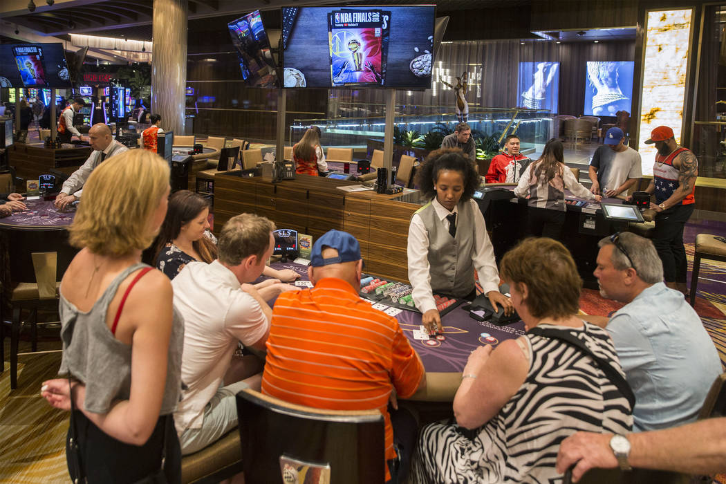 In this May 30, 2019, file photo, gamblers play blackjack at SLS Las Vegas in Las Vegas. (Benja ...