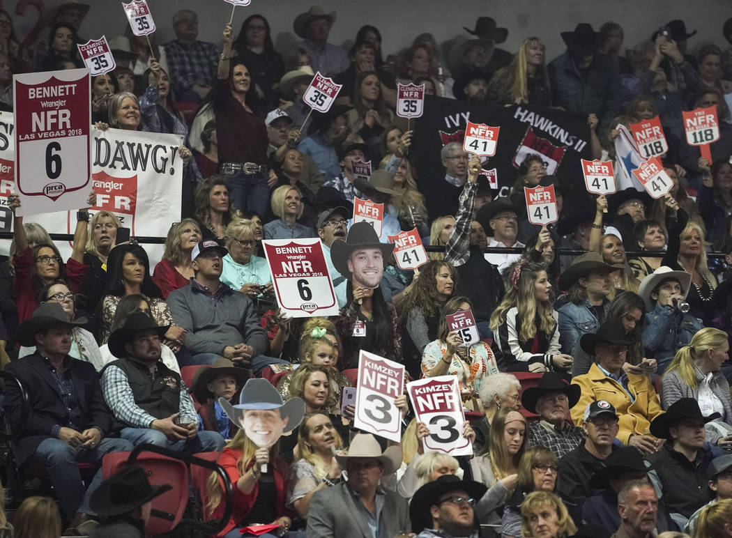 Spectators cheer during the eighth go-round of the National Finals Rodeo at the Thomas & Mack C ...