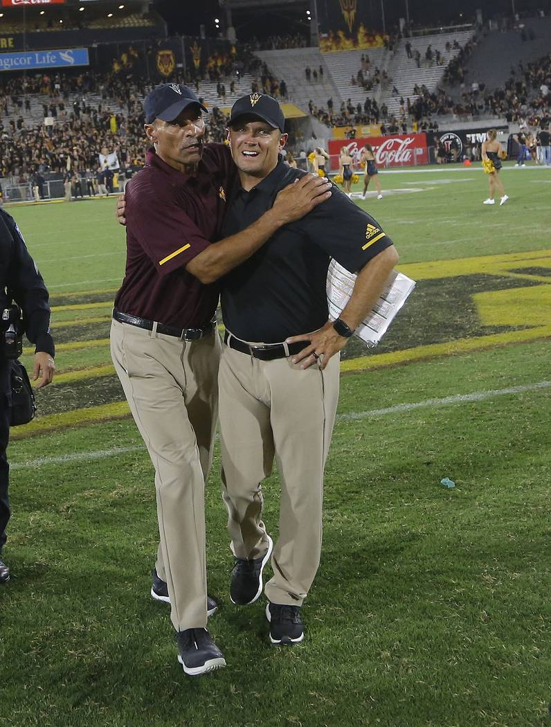 Arizona State head coach Herm Edwards, left, celebrates a win against Michigan State with defen ...