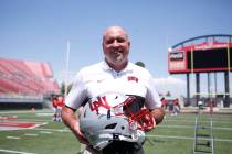 UNLV football head coach Tony Sanchez holds a unique helmet that will be worn by the players on ...