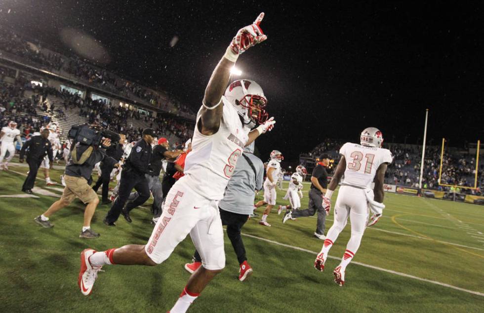 UNLV's Aaron Criswell (9) celebrates after the teams 23-17 defeat over UNR at Mackay Stadium in ...