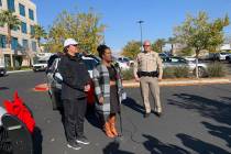 Latoya Holman, director of community outreach with the LVMPD Foundation, center, said officers ...