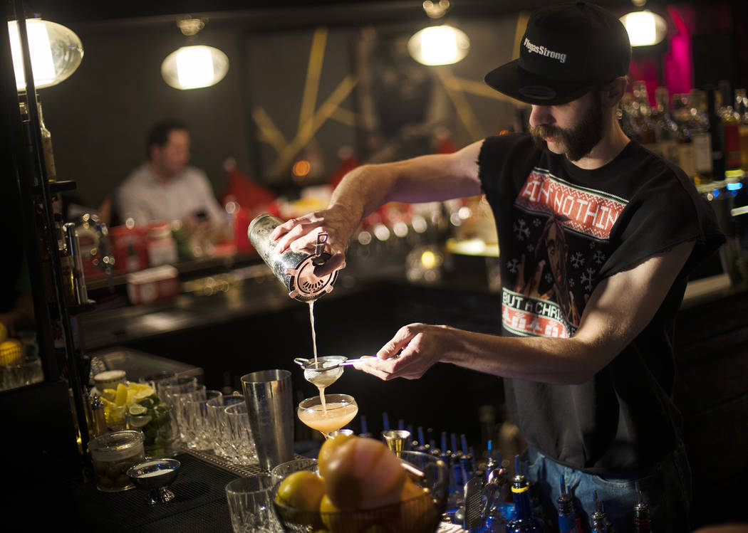 Bartender Keith Baker creates the Christmapolitan, made of vodka, elderflower, dry vermouth, sp ...