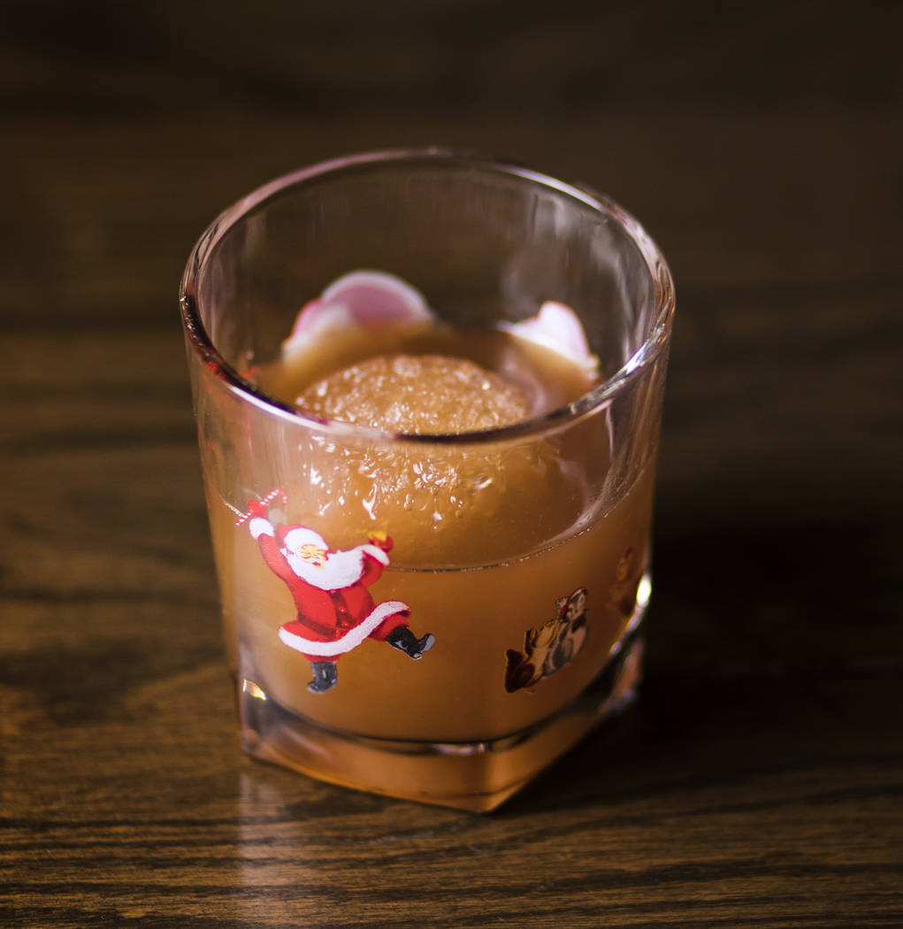 The Snowball Old-Fashioned made of caramelized pecan bourbon, spiced molasses syrup, wormwood b ...