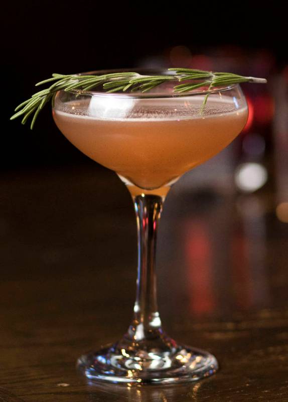 The Christmapolitan is made of vodka, elderflower, dry vermouth, spiced cranberry sauce, rosema ...