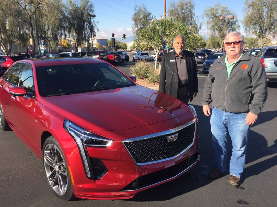 New Las Vegas resident Leonard Duchene, right, is seen with Findlay Cadillac sales consultant M ...