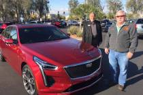 New Las Vegas resident Leonard Duchene, right, is seen with Findlay Cadillac sales consultant M ...