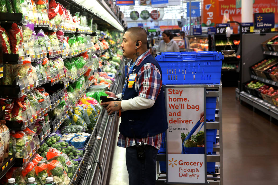 Personal shopper Melvin Oasay fills customer orders for pickup at Walmart at 7200 Arroyo Crossi ...