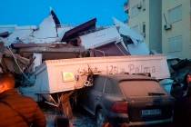 People stand next to a damaged hotel after an earthquake, in Durres, western Albania, Tuesday, ...