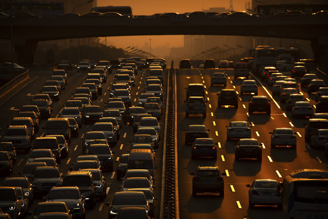 In a Friday, Sept. 6, 2019, file photo, commuters make their way along an expressway during rus ...