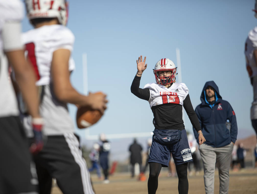 Liberty High School quarterback Daniel Britt (18) motions for the ball during practice on Tuesd ...