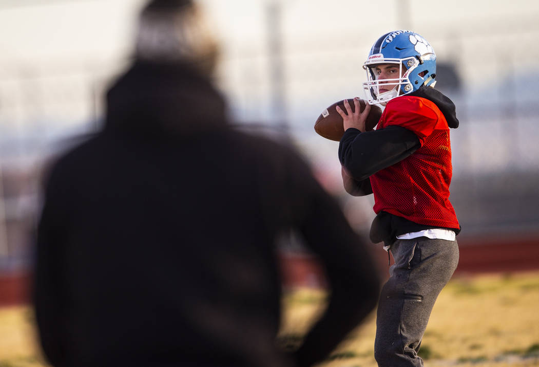 Centennial quarterback Colton Tenney looks to throw the ball during football practice at Centen ...