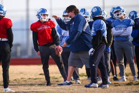 Centennial football coach Dustin Forshee, right, motions in front of quarterback Colton Tenney, ...