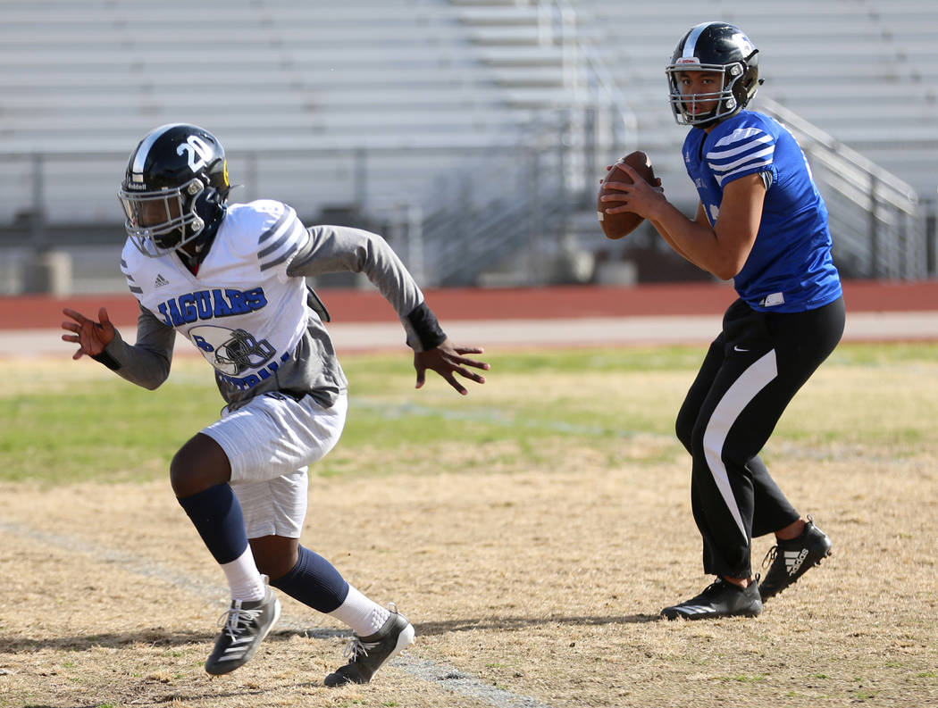 Desert Pines' Rjay Tagataese (15) looks to make a pass to DeAvonte McGee (20) during a team pra ...