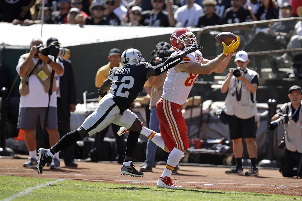 Kansas City Chiefs tight end Travis Kelce scores a touchdown as Oakland Raiders free safety Kar ...