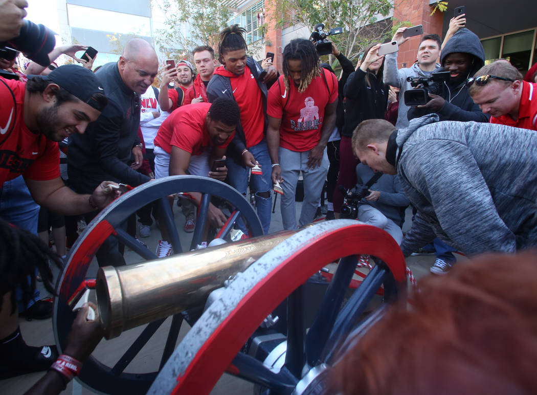 UNLV students and officials watch as UNLV's football players, including kicker Evan Pantels, ri ...