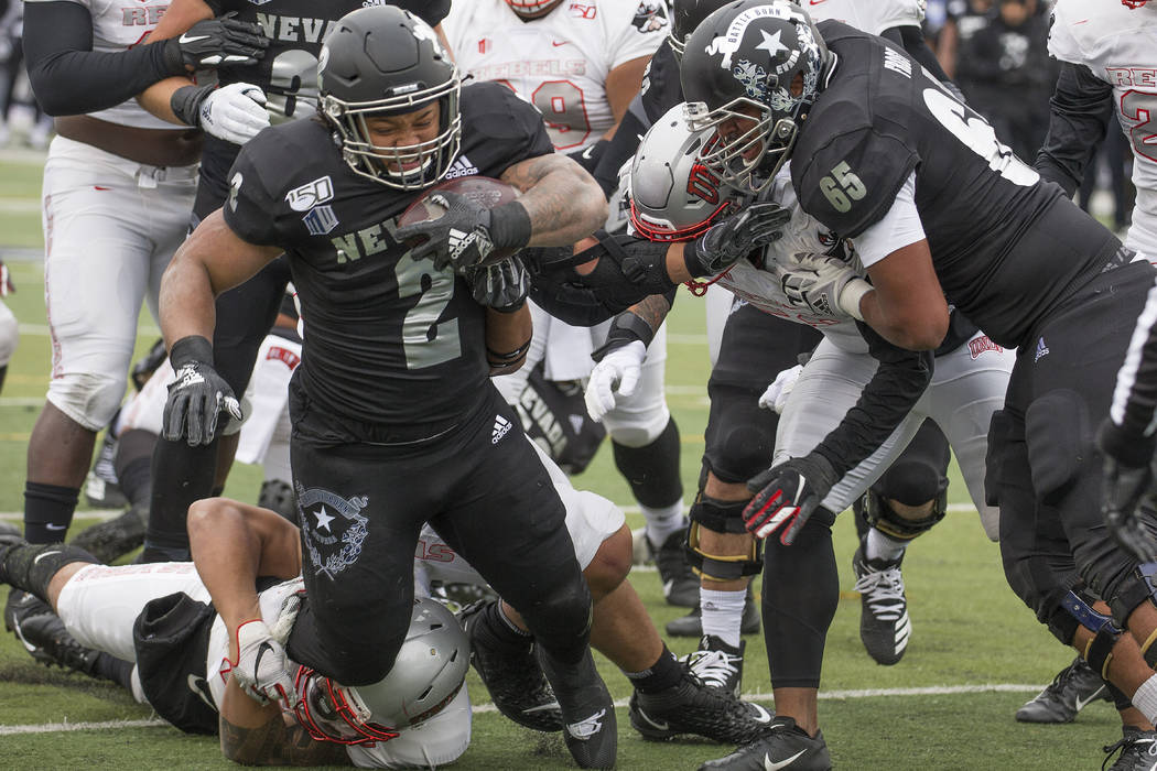 Nevada running back Devonte Lee (2) dives into the end zone for a touchdown against UNLV in the ...