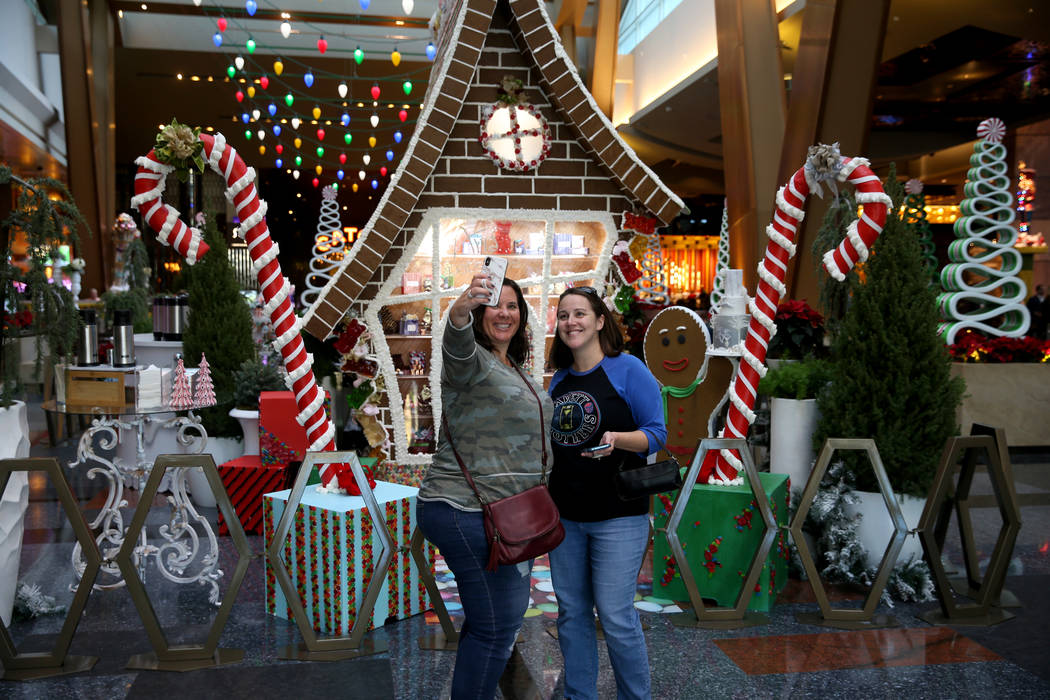 Paula Dymond of Toronto, left, and Jen Jakubowicz of Philadelphia pose in front of a 15-foot-ta ...