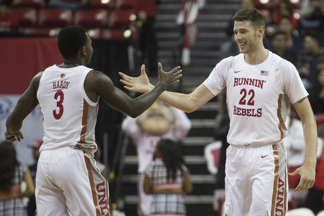 UNLV Rebels guard Amauri Hardy (3) celebrates with UNLV Rebels forward Vitaliy Shibel (22) afte ...