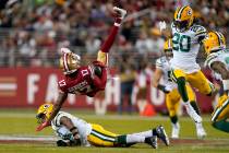 San Francisco 49ers wide receiver Emmanuel Sanders (17) falls backward over Green Bay Packers s ...