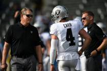 Oakland Raiders quarterback Derek Carr (4) talks with Oakland Raiders head coach Jack Del Rio, ...