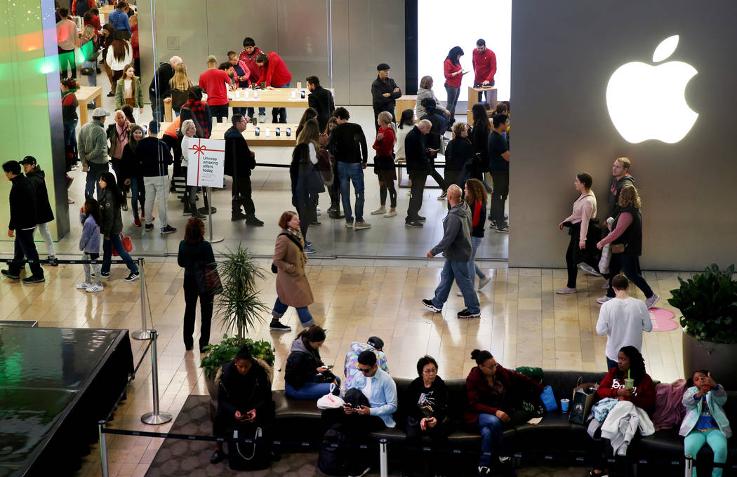 Shoppers browse at the Apple Store at Fashion Show mall in Las Vegas Friday, Nov. 29, 2019. (K. ...