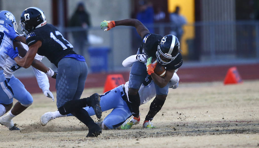 Centennial's Donte Washington (3) stops Desert Pines' Javontae Barnes (22) during the first hal ...