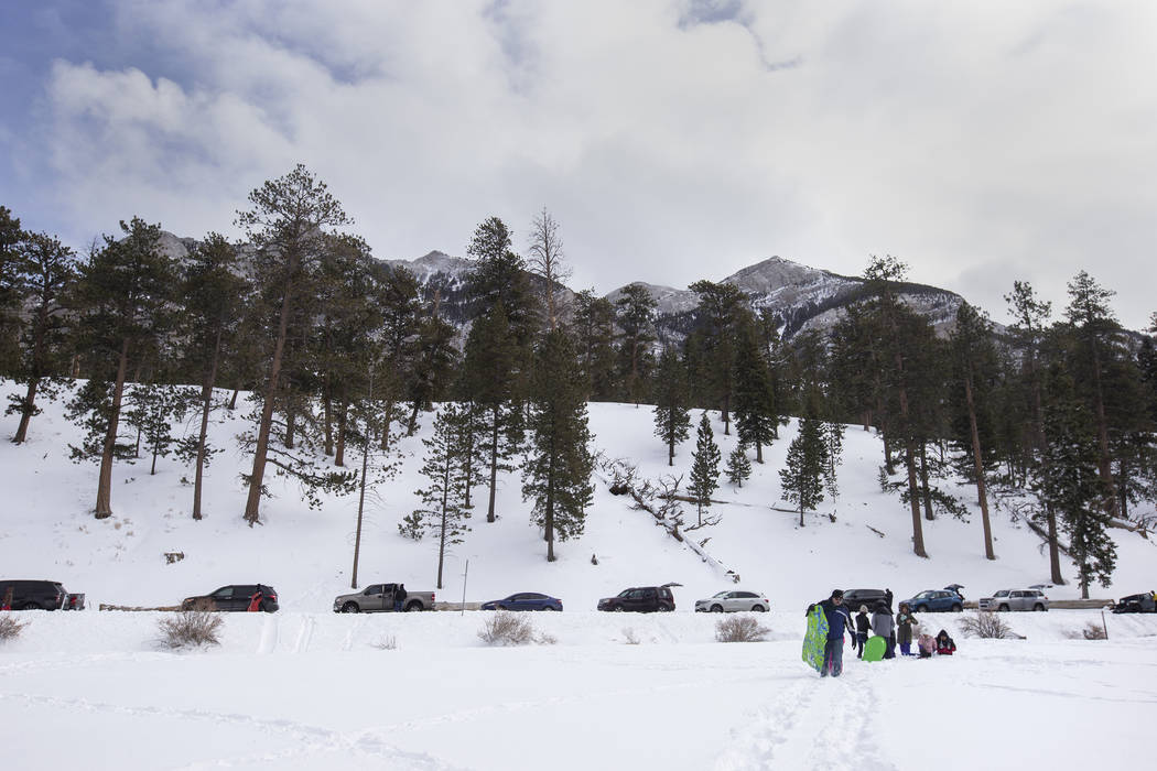 Vehicles park along Lee Canyon Road to experience the snow at Upper Lee Meadows on Thursday, No ...