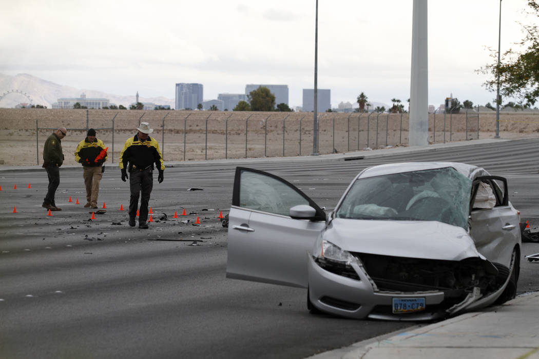 Las Vegas police officers investigate a fatal crash at Durango Drive and Russell Road in southw ...