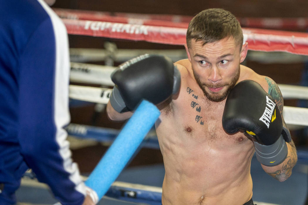 Former two-weight world boxing champion Carl Frampton, right, boxes with trainer Jamie Moore at ...