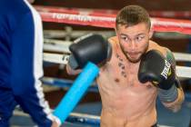 Former two-weight world boxing champion Carl Frampton, right, boxes with trainer Jamie Moore at ...