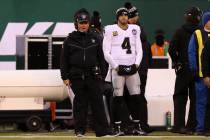 Oakland Raiders head coach Jon Gruden and Oakland Raiders quarterback Derek Carr (4) stand on t ...