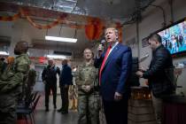 President Donald Trump speaks at a dinning facility during a surprise Thanksgiving Day visit to ...