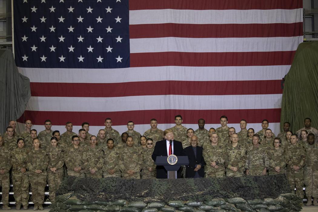President Donald Trump addresses members of the military during a surprise Thanksgiving Day vis ...