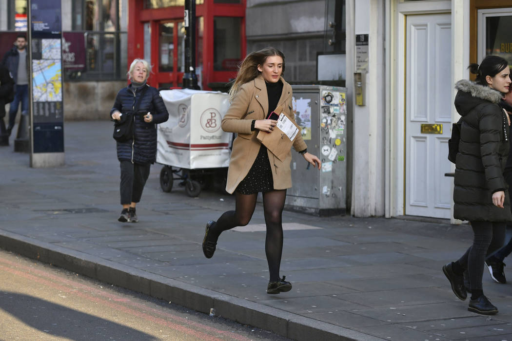 People are evacuated from London Bridge in central London following a police incident, Friday, ...