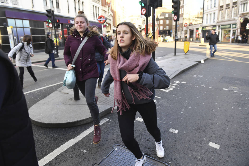 People are evacuated from London Bridge in central London following a police incident, Friday, ...