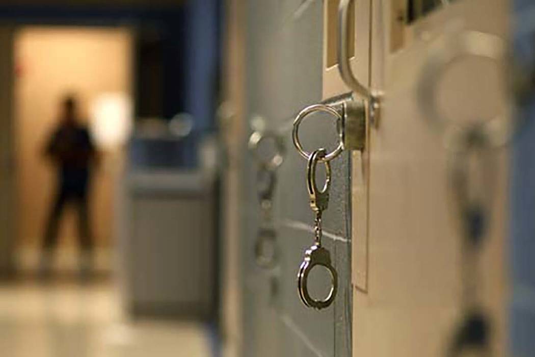 Handcuffs hang from the wall in the North Las Vegas jail in North Las Vegas Thursday, Aug. 23, ...