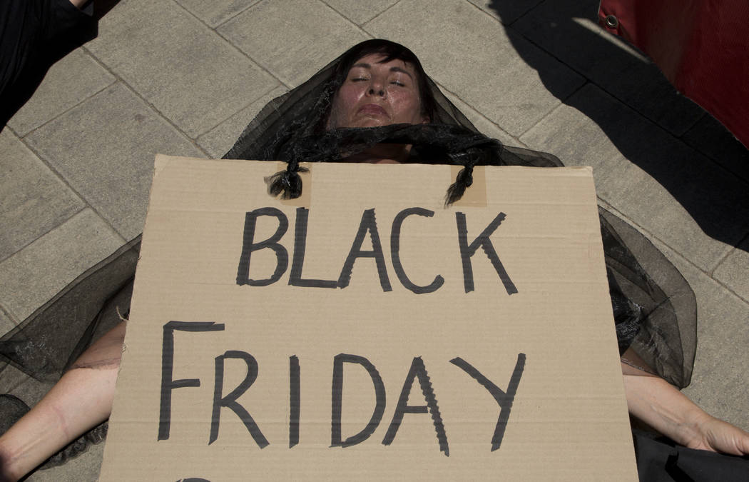 A demonstrator "plays dead" during climate change protest outside the Johannesburg St ...