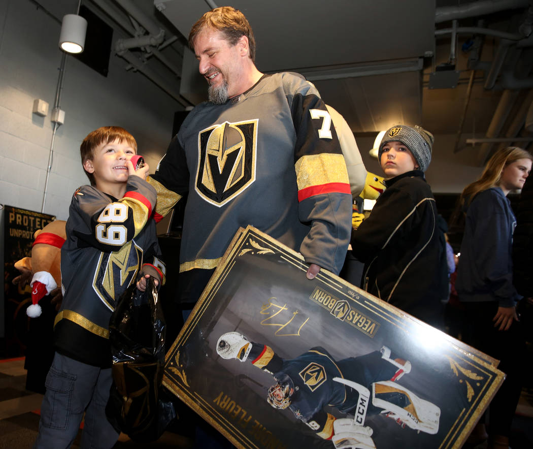 Silus Wells, 5, and his dad Steve Wells of Las Vegas show off their purchases at The Arsenal re ...