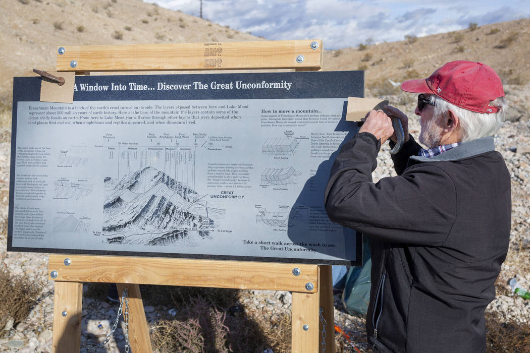 UNLV Geology Professor Steve Rowland sets up a granite sign explaining the history of the Great ...