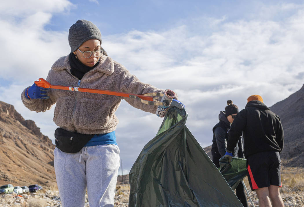 Volunteer for Get Outdoors Nevada Jasmine Upperman of Los Angeles cleans up trash near the trai ...