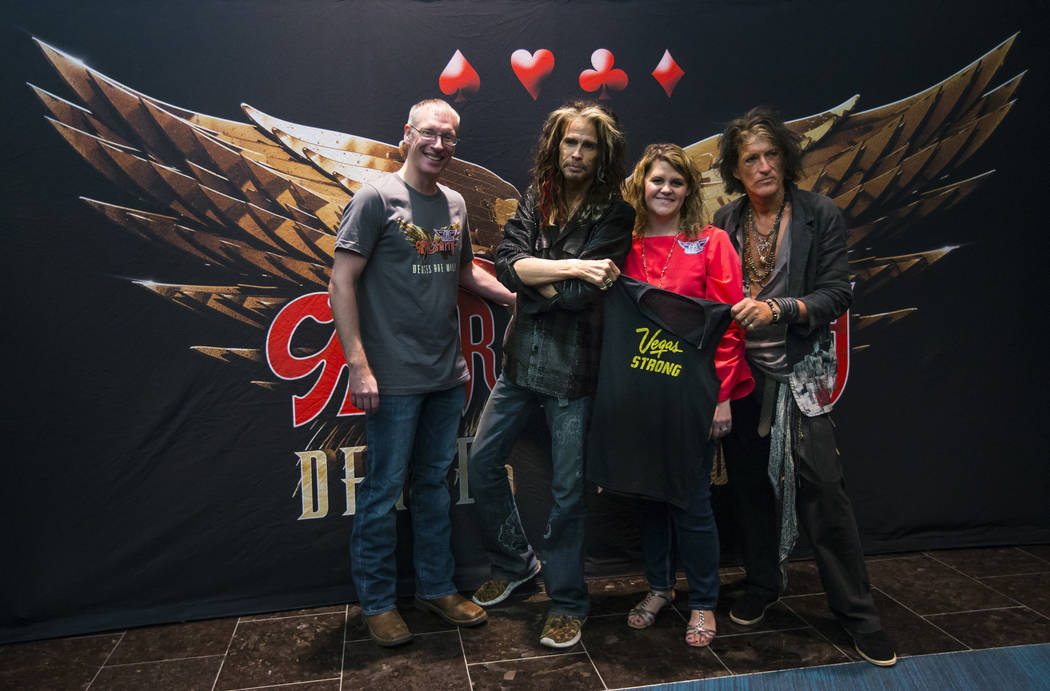 Kris Dahl, left, and Barbie Dahl of Las Vegas, pose with Steven Tyler, second from left, and Jo ...