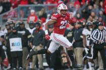 Wisconsin's Jonathan Taylor runs for a touchdown during the first half of an NCAA college footb ...