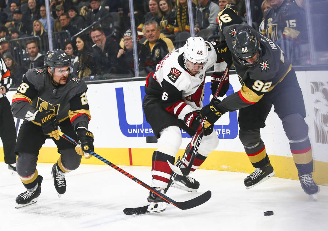 Golden Knights' Tomas Nosek (92) battles for the puck against Arizona Coyotes' Jakob Chychrun ( ...