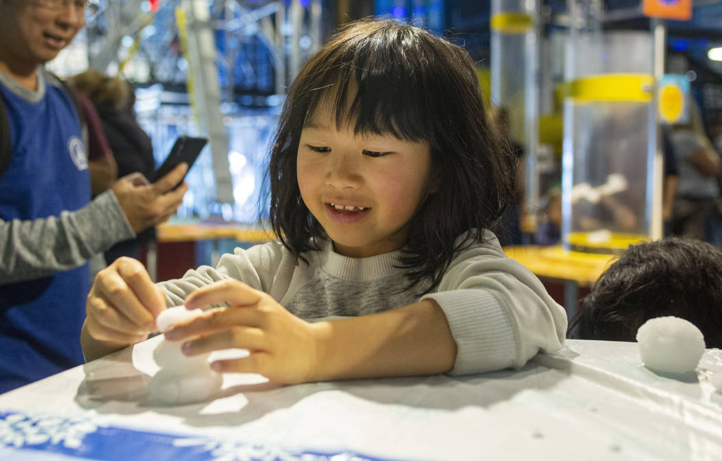 Audrey Chen, 7, of San Fransisco, makes a miniature snowman at theʄiscovery Children's Mu ...