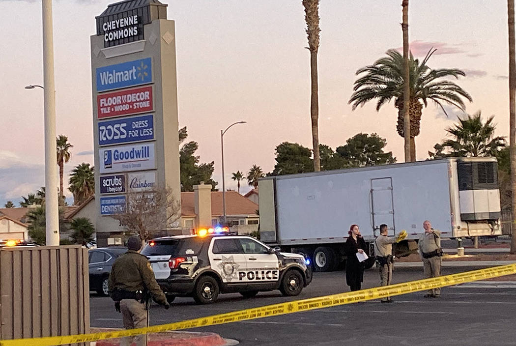 Las Vegas police officers respond to the scene of a shooting near the entry of the Cheyenne Com ...