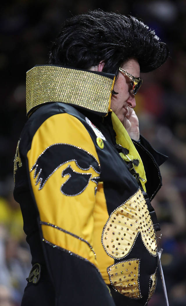 University of Iowa fan Greg Suckow wears an Elvis costume, as he does for every game, during th ...