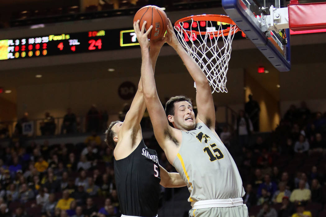 University of Iowa's Ryan Kriener (15) dunks the ball as San Diego State University's forward Y ...