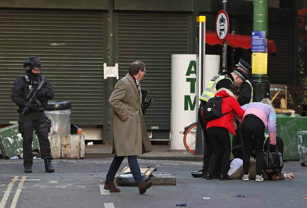 A person is assisted after falling when Police evacuated people from Borough Market on the sout ...