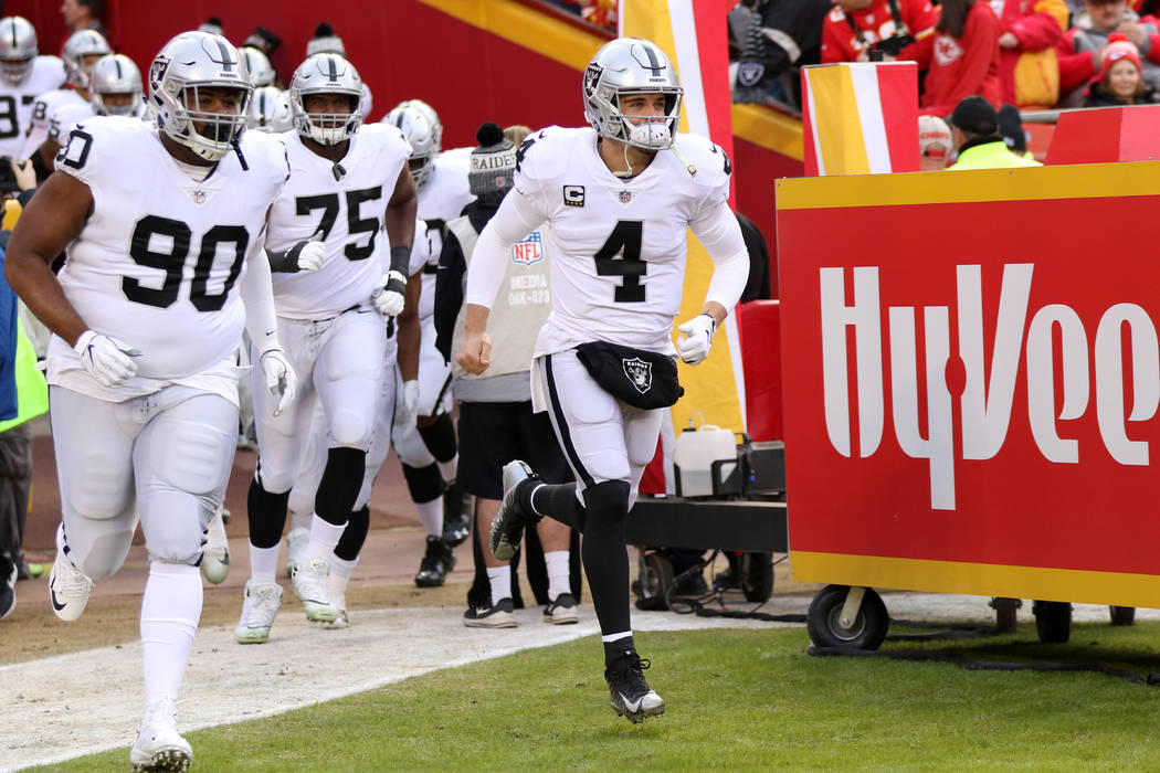 Oakland Raiders quarterback Derek Carr (4) leads his team on the field before the start of an N ...